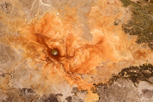 Texture of the ground with blood color, underground water. photo