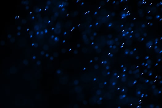 Flowing and glowing particles with dark background, 3d rendering photo