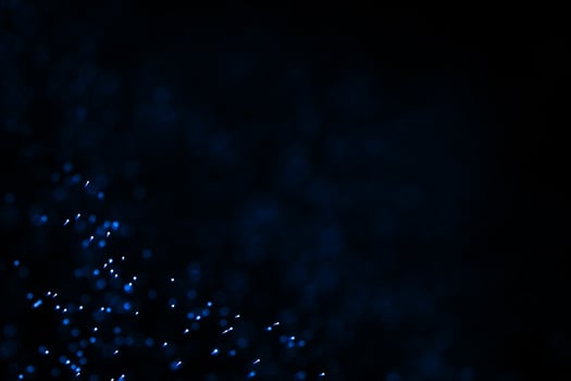 Flowing and glowing particles with dark background, 3d rendering photo