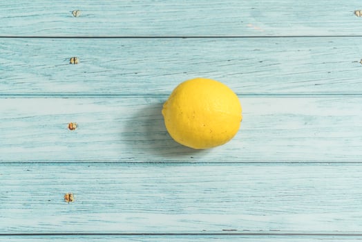 the fruit lemon on the blue table, cool light background photo