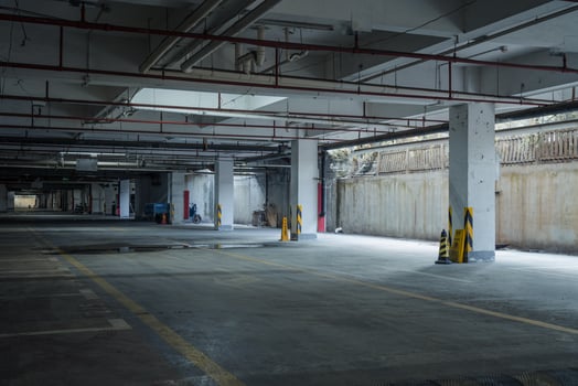 old parking lot with lighting, concrete building photo
