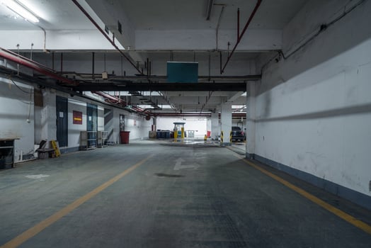 old parking lot with lighting, concrete building photo