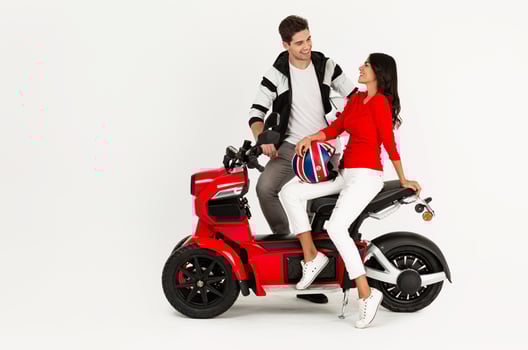 young attractive couple riding an electric motorbike scooter happy having fun together photo
