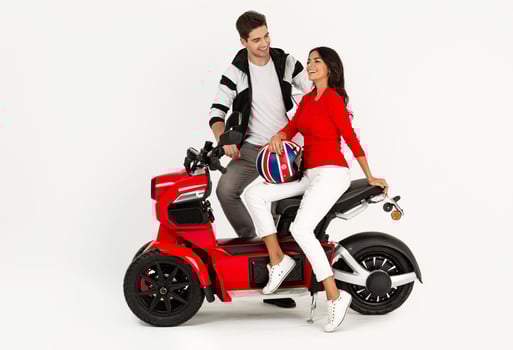 young attractive couple riding an electric motorbike scooter happy having fun together photo