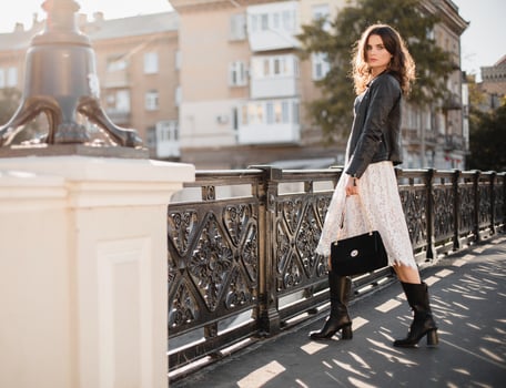 attractive woman walking in street in fashionable outfit photo