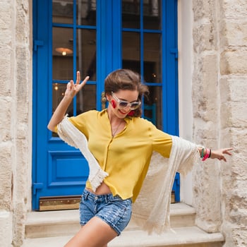 young beautiful stylish woman walking in old city street photo