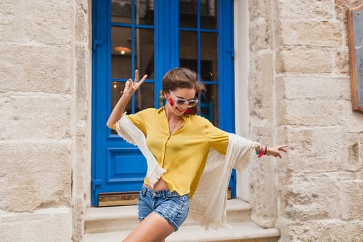 young beautiful stylish woman walking in old city street photo