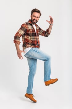 handsome bearded man in hipster outfit dressed in jeans and checkered shirt photo