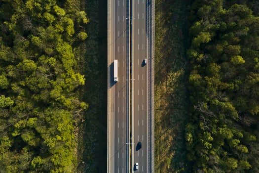 Aerial view of highway road with moving cars photo