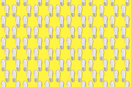 White sneakers on yellow background, Seamless pattern photo
