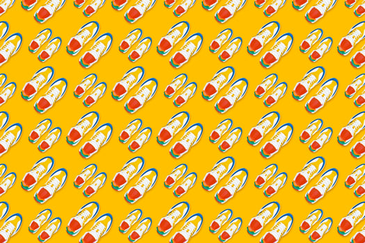Colorful sneakers on yellow background, Seamless pattern photo