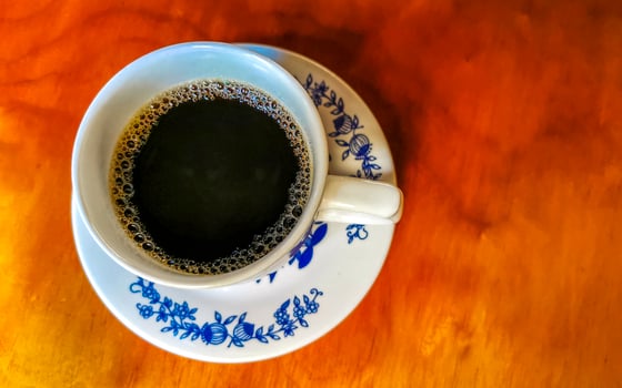 Blue white cup pot with black coffee wooden table Mexico. photo