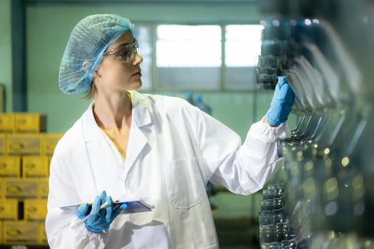 Female researcher carrying out scientific research in drinking water factory photo