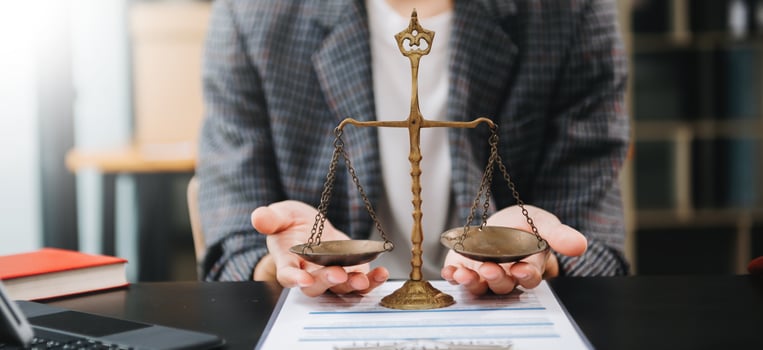 Male lawyer in the office with brass scale on wooden table. justice and law concept in morning light photo
