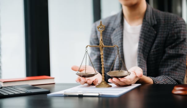 Male lawyer in the office with brass scale on wooden table. justice and law concept in morning light photo