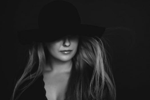 Beautiful blonde woman wearing a hat, artistic film portrait in black and white for fashion campaign and beauty brand photo