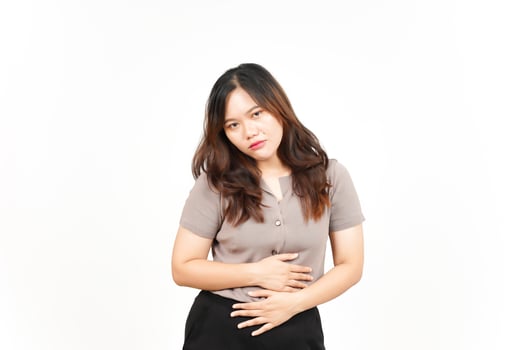 Suffering Stomachache Gesture Of Beautiful Asian Woman Isolated On White Background photo