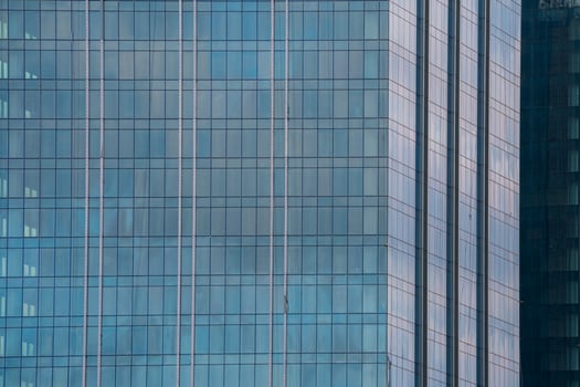 Glass facade of modern city high rise, buildings Glowing windows of skyscrapers. photo