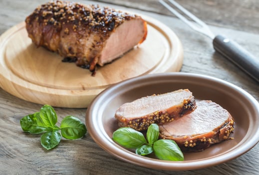 Baked pork meat wrapped in bacon photo