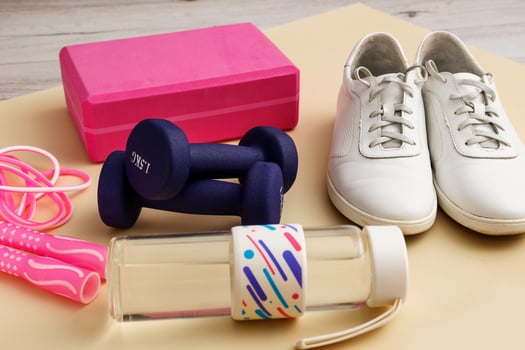 sneakers with dumbbells, jump rope, yoga brick and water bottle, sports activities photo
