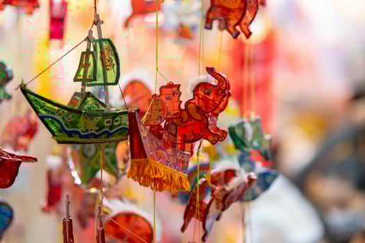 Decorated colorful lanterns hanging on a stand in the streets in Ho Chi Minh City, Vietnam during Mid Autumn Festival. Chinese language in photos mean money and happiness