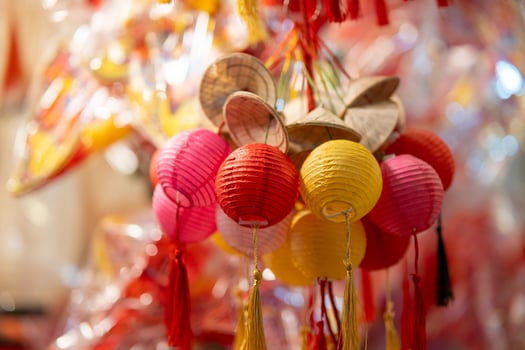 Decorated colorful lanterns hanging on a stand in the streets in Ho Chi Minh City, Vietnam during Mid Autumn Festival. Chinese language in photos mean money and happiness