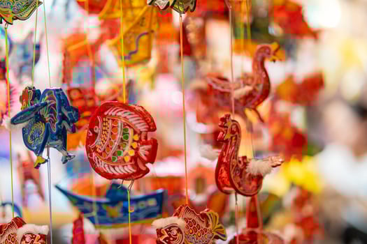 Decorated colorful lanterns hanging on a stand in the streets in Ho Chi Minh City, Vietnam during Mid Autumn Festival. Chinese language in photos mean money and happiness. Selective focus.