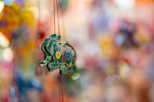 Decorated colorful lanterns hanging on a stand in the streets in Ho Chi Minh City, Vietnam during Mid Autumn Festival. Chinese language in photos mean money and happiness. Selective focus.