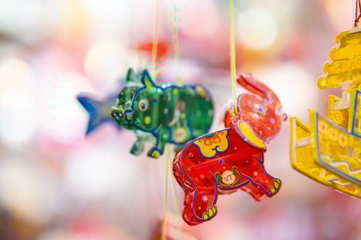 Decorated colorful lanterns hanging on a stand in the streets in Ho Chi Minh City, Vietnam during Mid Autumn Festival. Chinese language in photos mean money and happiness