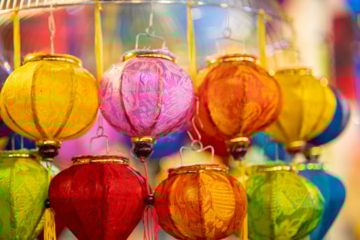 Decorated colorful lanterns hanging on a stand in the streets in Ho Chi Minh City, Vietnam during Mid Autumn Festival. Chinese language in photos mean money and happiness