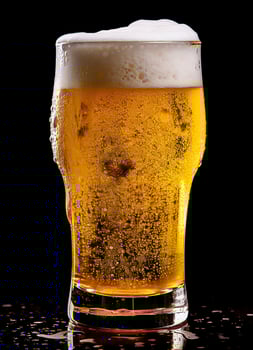 A glass of cold fresh beer with cap of foam. Splash of foam with tasty american beer. Beer day concept by AI Generated photo