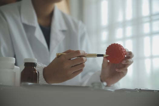 Doctor and patient sitting and talking at medical examination at hospital office, close-up. Therapist filling up medication history records. Medicine and healthcare concept. photo