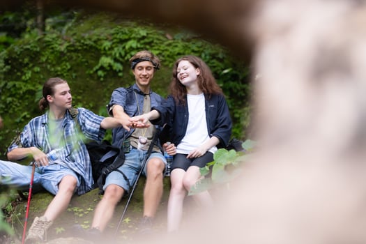 Group of young people hiking in the forest. Travel and adventure concept. photo