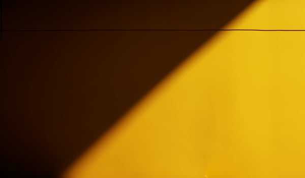 Half of yellow wall in shadow. AI generated photo
