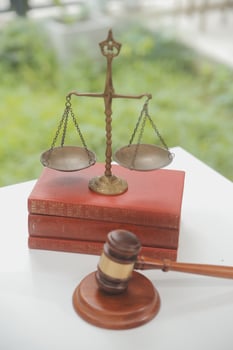 Business and lawyers discussing contract papers with brass scale on desk in office. Law, legal services, advice, justice and law concept picture with film grain effect photo