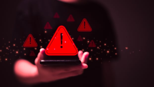 System warning caution sign on smartphone, scam virus attack on firewall for notification error and maintenance. Network security vulnerability, data breach, illegal connection and information danger. photo