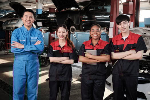 Portrait of multiracial professional mechanic team arms crossed and look at camera, work at car service garage, happy maintenance jobs, check and repair occupation in automotive industry business. photo