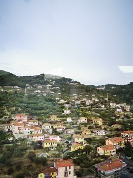 Photo of a picturesque hillside with charming houses and a majestic hill in the distance