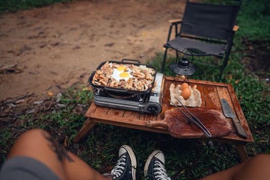 Fried eggs and grilled pork in a camping pan photo