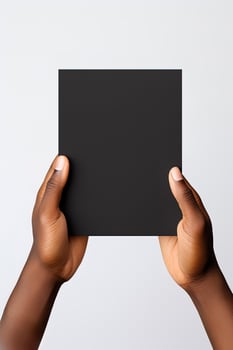 A human hand holding a blank sheet of black paper or card isolated on white background. ai generated photo