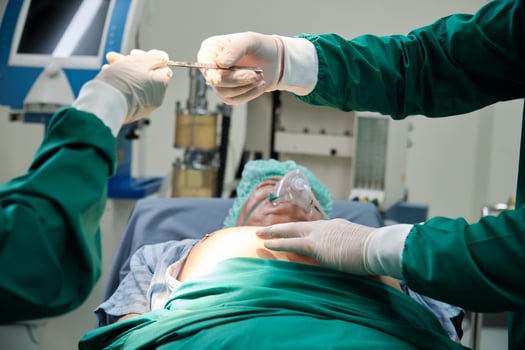 Close up, practitioner doctor gives knife to specialist surgeon's hand, prepares for surgery operations on critically ill patients in hospital's ICU, professional medical team. photo
