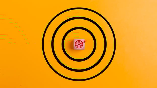 Concept of success. Target with a target icon on a wooden block on a yellow background the concept of achieving or targeting business goals. photo
