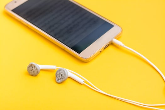 Listening to music using a smartphone and wired headphones. Leisure with gadgets photo