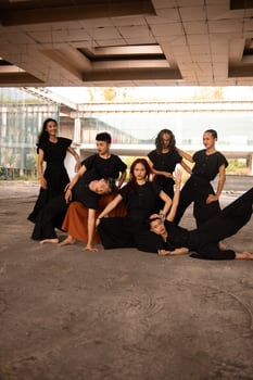 a group of Asian men posing cheerfully with their friends while wearing black photo