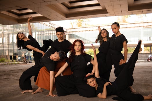 a group of Asian men posing cheerfully with their friends while wearing black photo