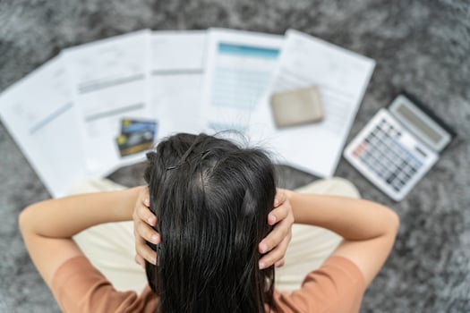 Stressed and headache woman with large bills or invoices no money to pay to expenses and credit card debt. shortage, Financial problem, bankruptcy, mortgage, loan, bankrupt, poor, empty wallet photo