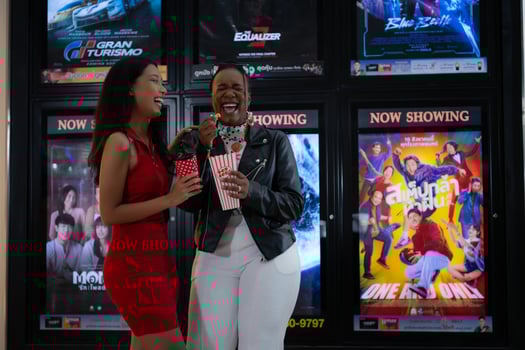 Both of young woman stand and watch the movie program to watch today. photo