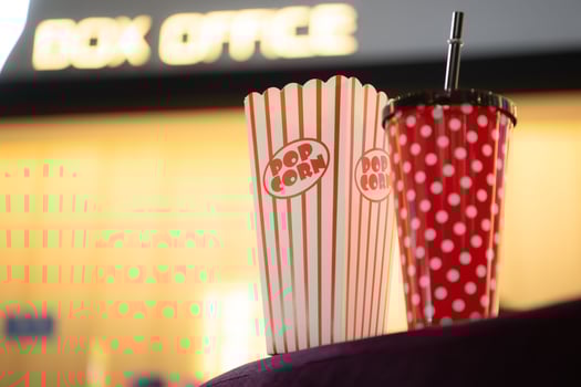 Popcorn and drinking glass a companion item of people for watching movies in the cinema. photo