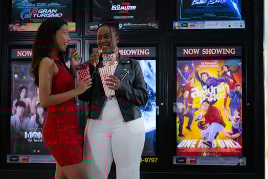 Both of young woman stand and watch the movie program to watch today. photo
