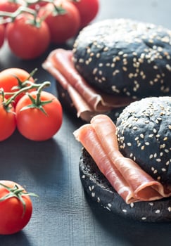 Black sandwich with prosciutto ham photo